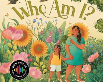 UPPAA A book cover titled "Who Am I?" features an adult and a child standing in a colorful, lush garden with various plants and flowers. Both are looking up, with vibrant flowers and green leaves surrounding them. The book is written by Julie Buchholtz and illustrated by Aliya Ghare.